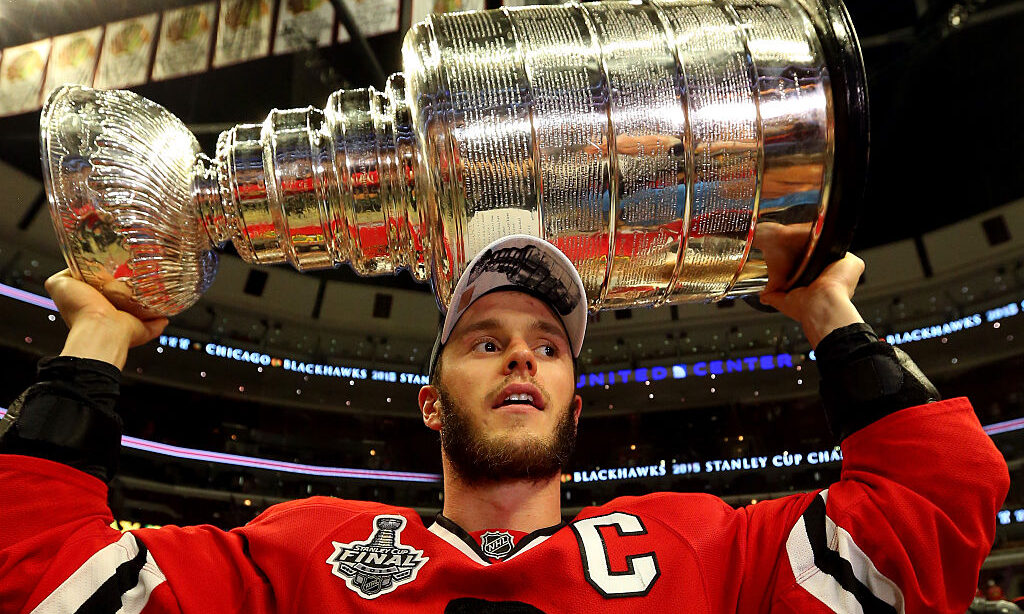 Jonathan Toews #19 of the Chicago Blackhawks celebrates by hoisting the Stanley Cup...